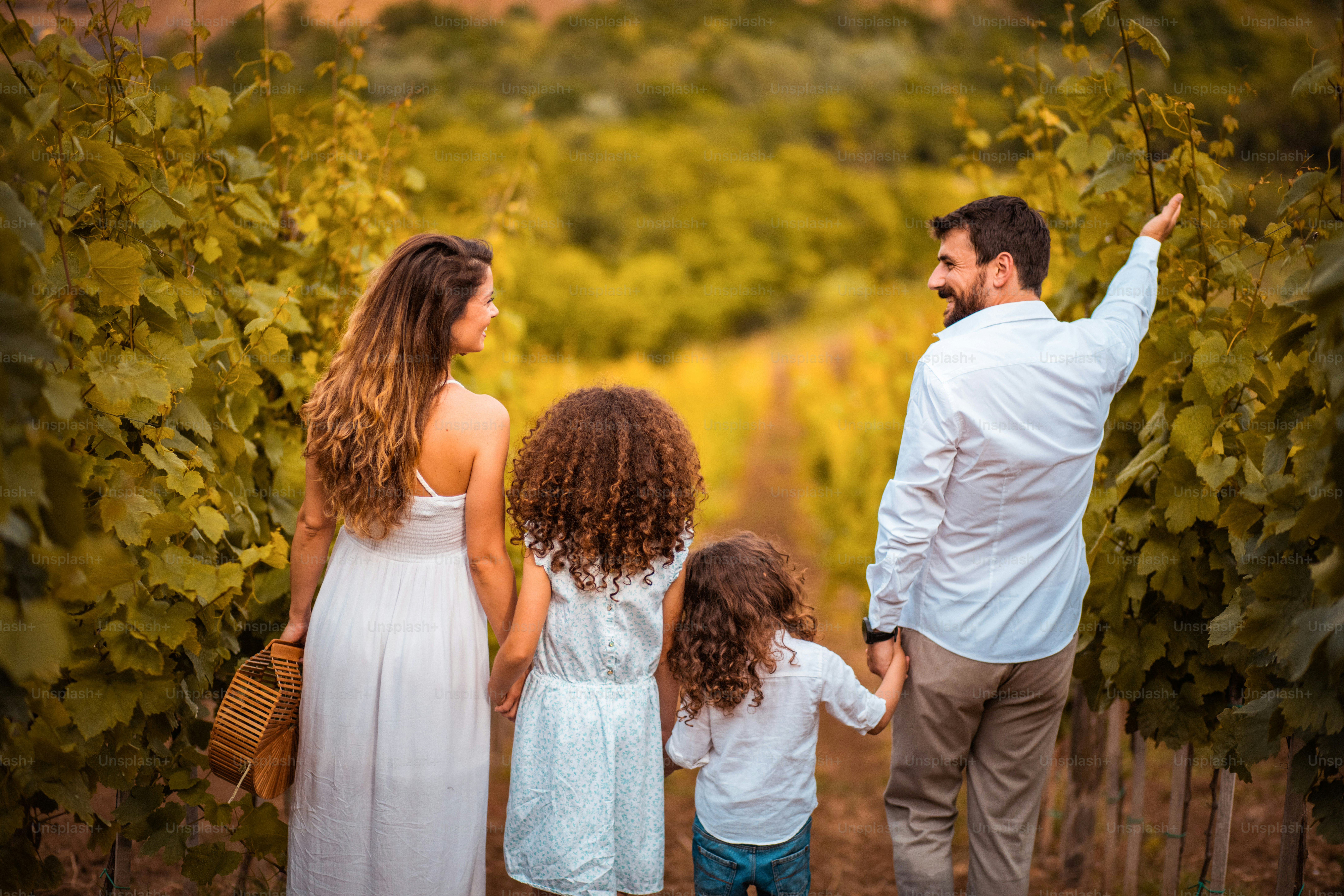 Family standing in vineyard.