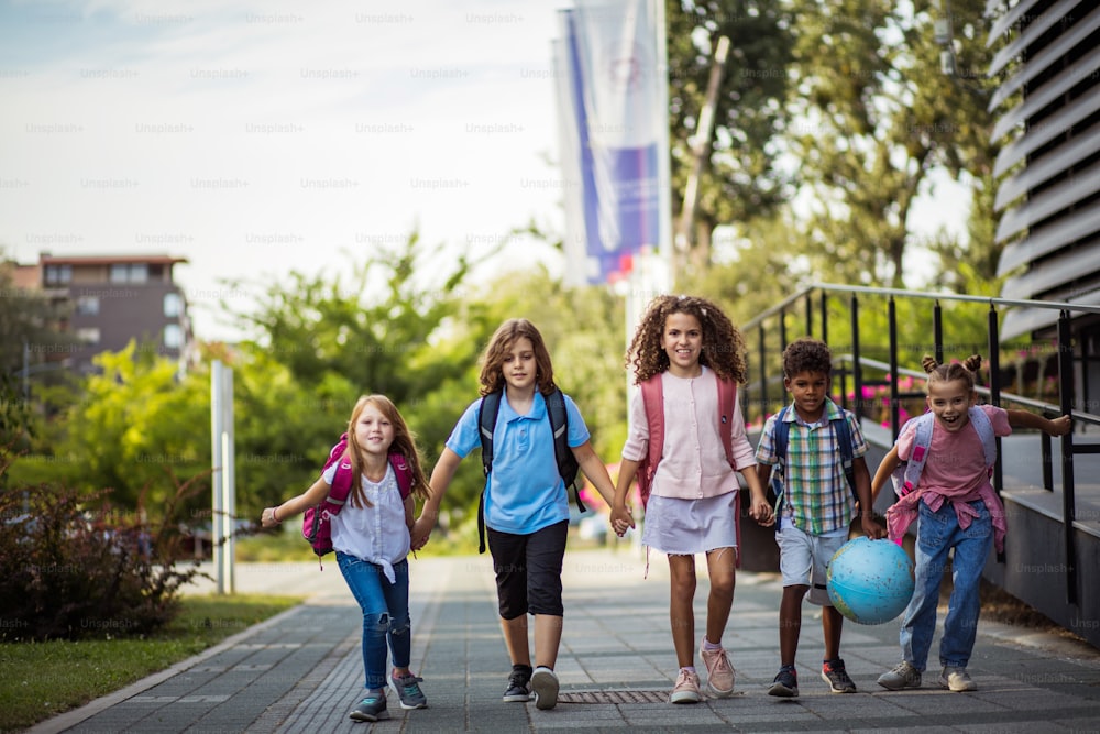 Group of elementary age schoolchildren outside.