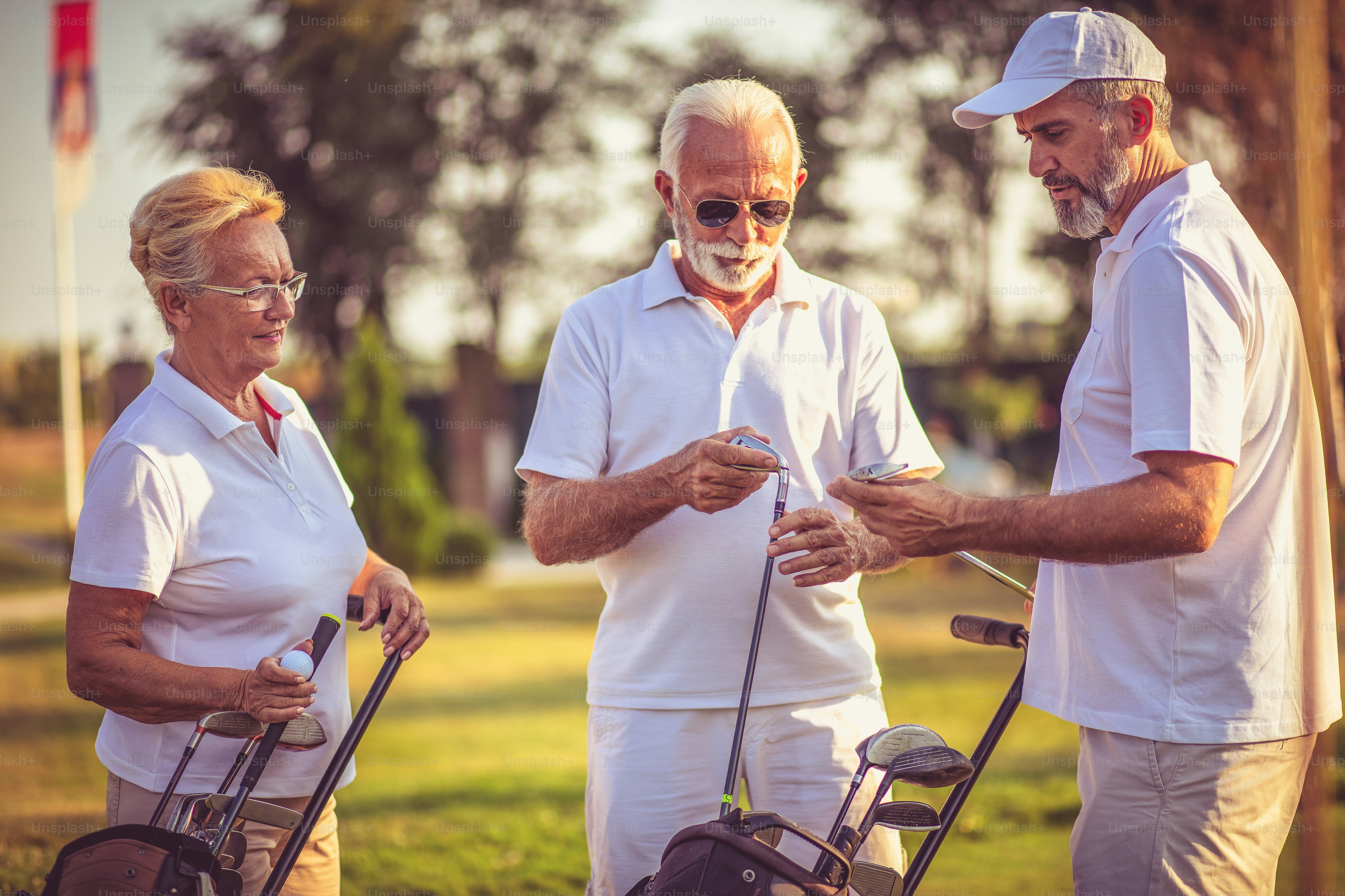 Senior friends on golf court talking