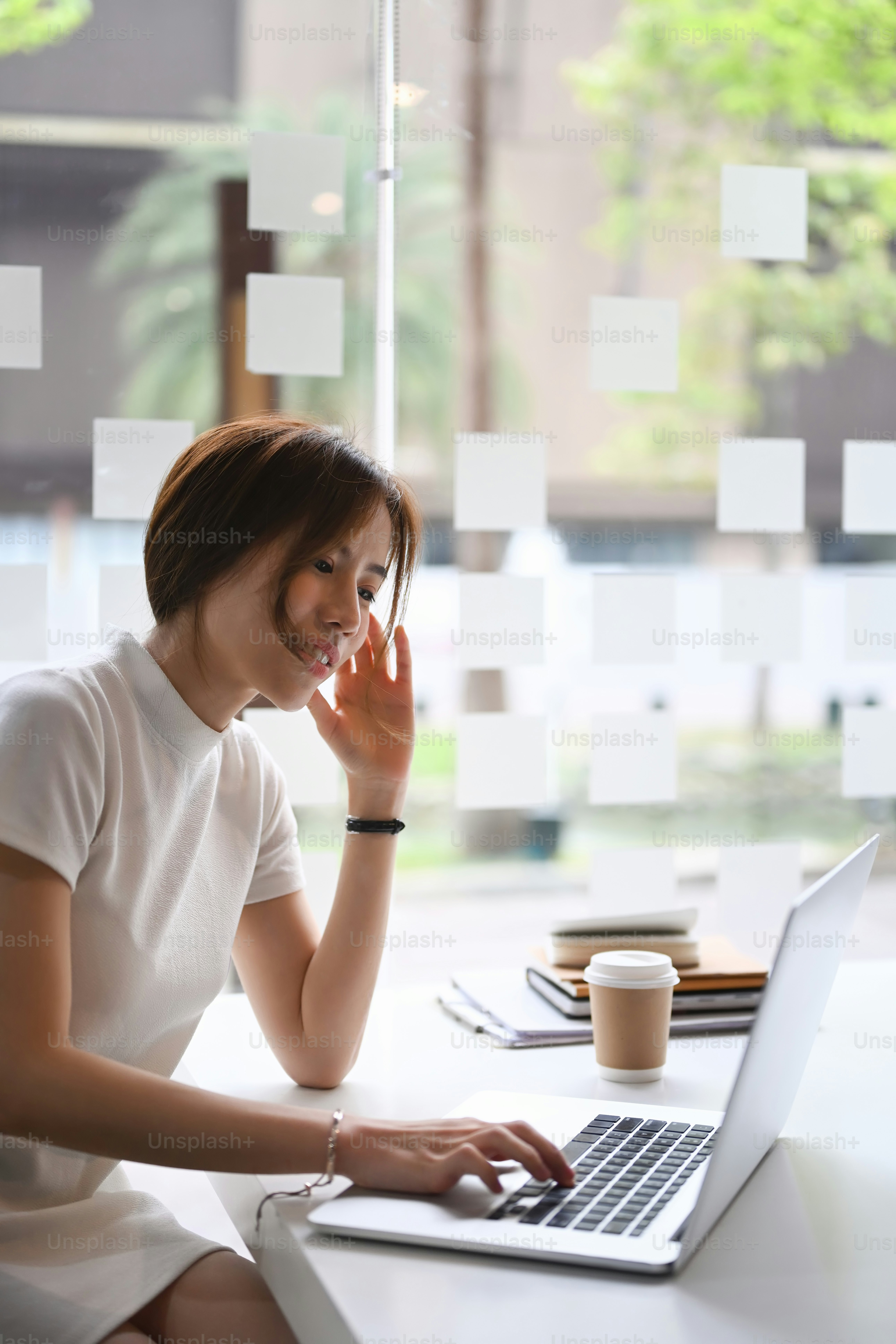 Tired businesswoman holding her head feeling overworked and sleepy.