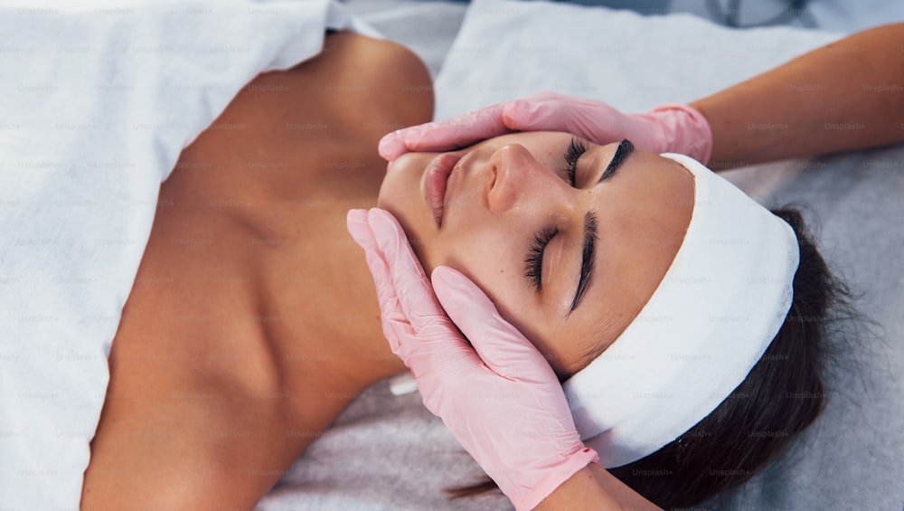 Close up view of woman that lying down in spa salon and have face cleaning procedure.