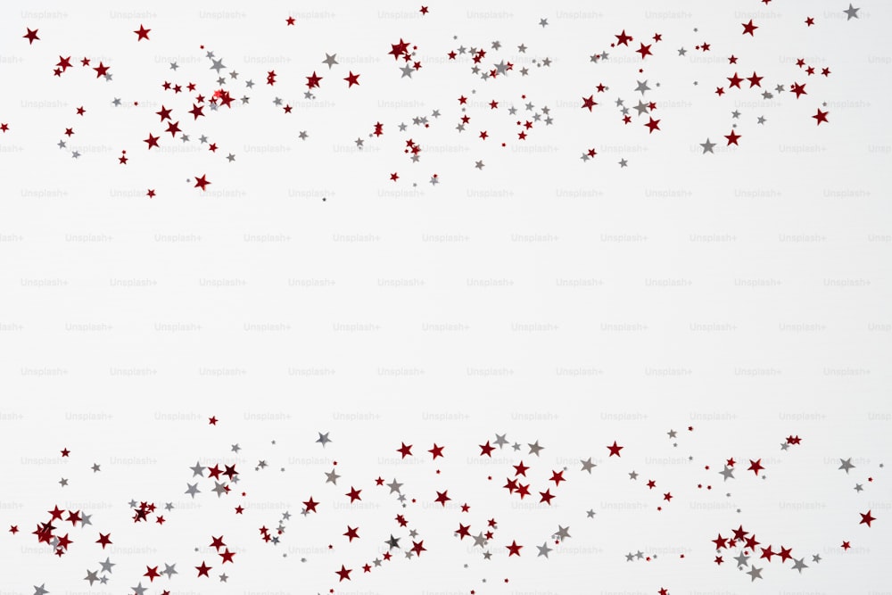 Red and white confetti stars on white background. Happy Canada Day banner design. Flat lay, top view, copy space.