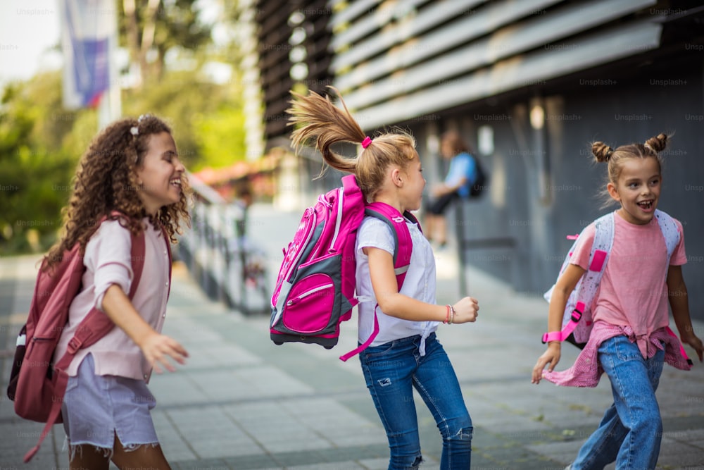 Three school girls outside.