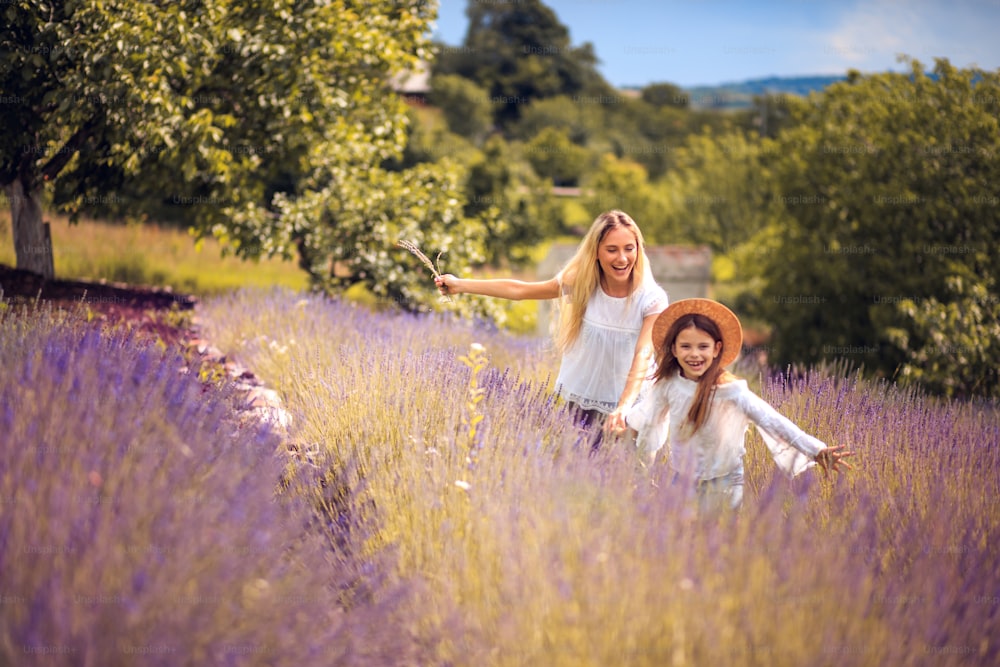 Mother and daughter  in lavender field. Focus is on woman.