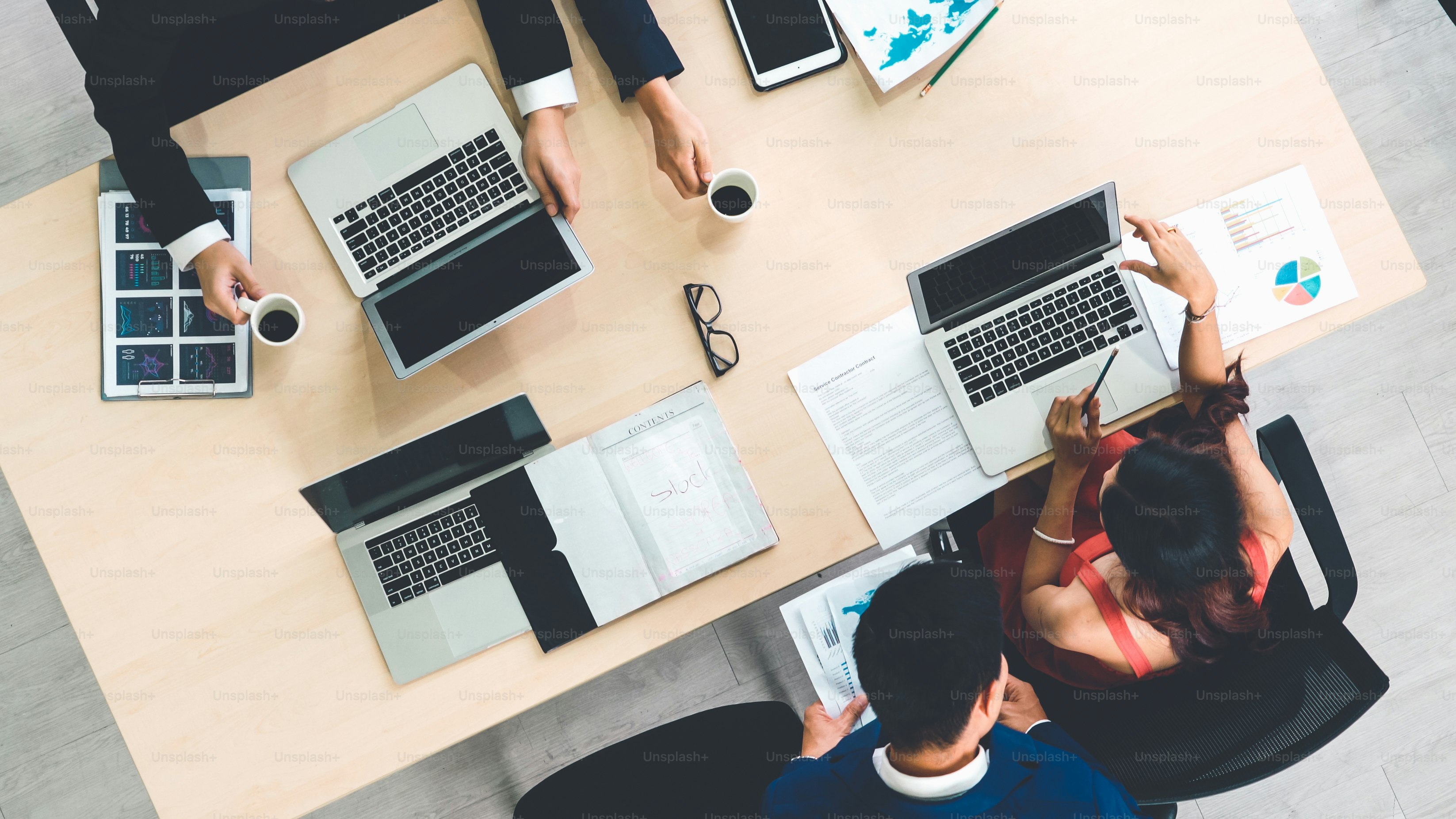 Business people group meeting shot from top view in office . Profession businesswomen, businessmen and office workers working in team conference with project planning document on meeting table .