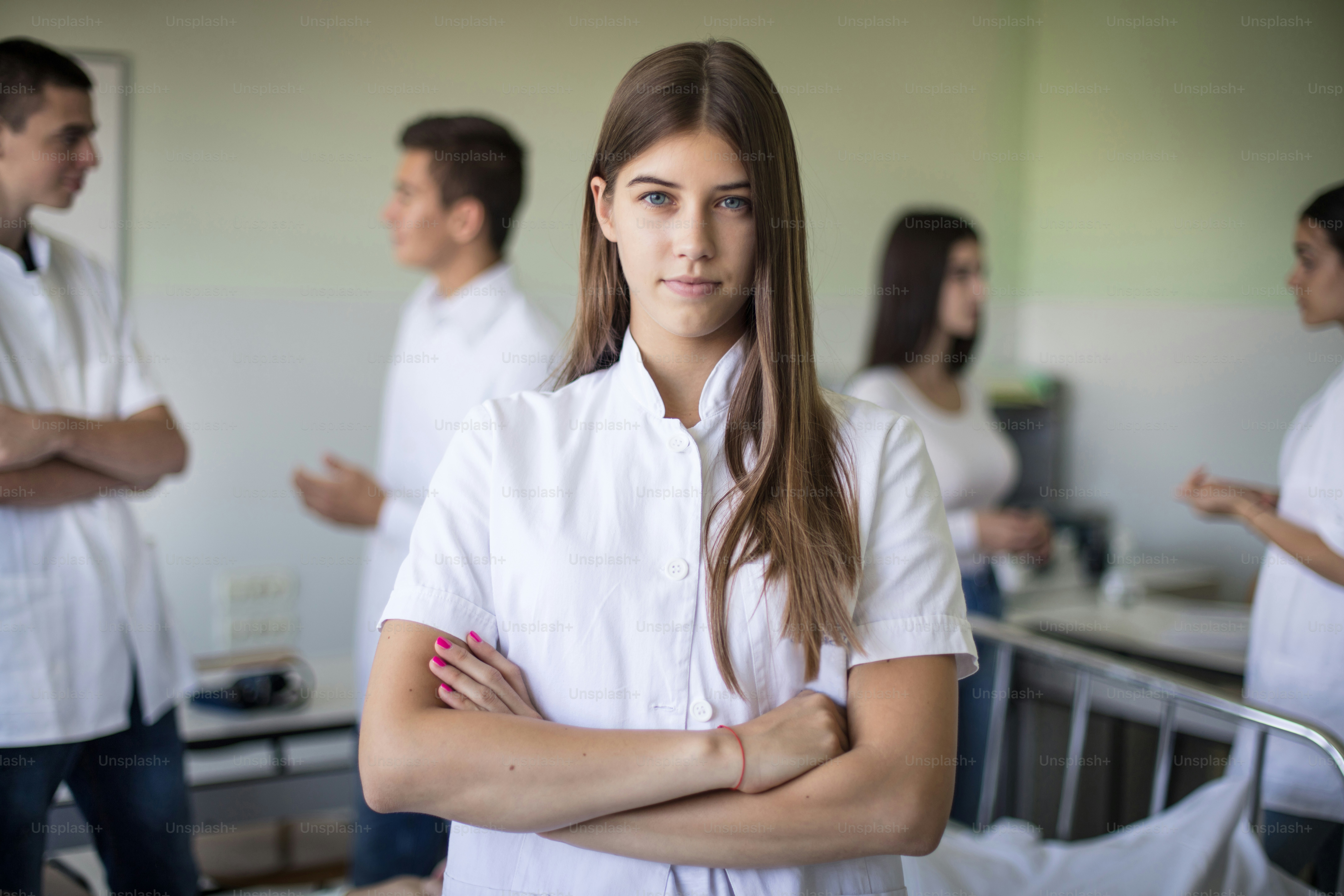 Medical students in patient room. Focus is on foreground.