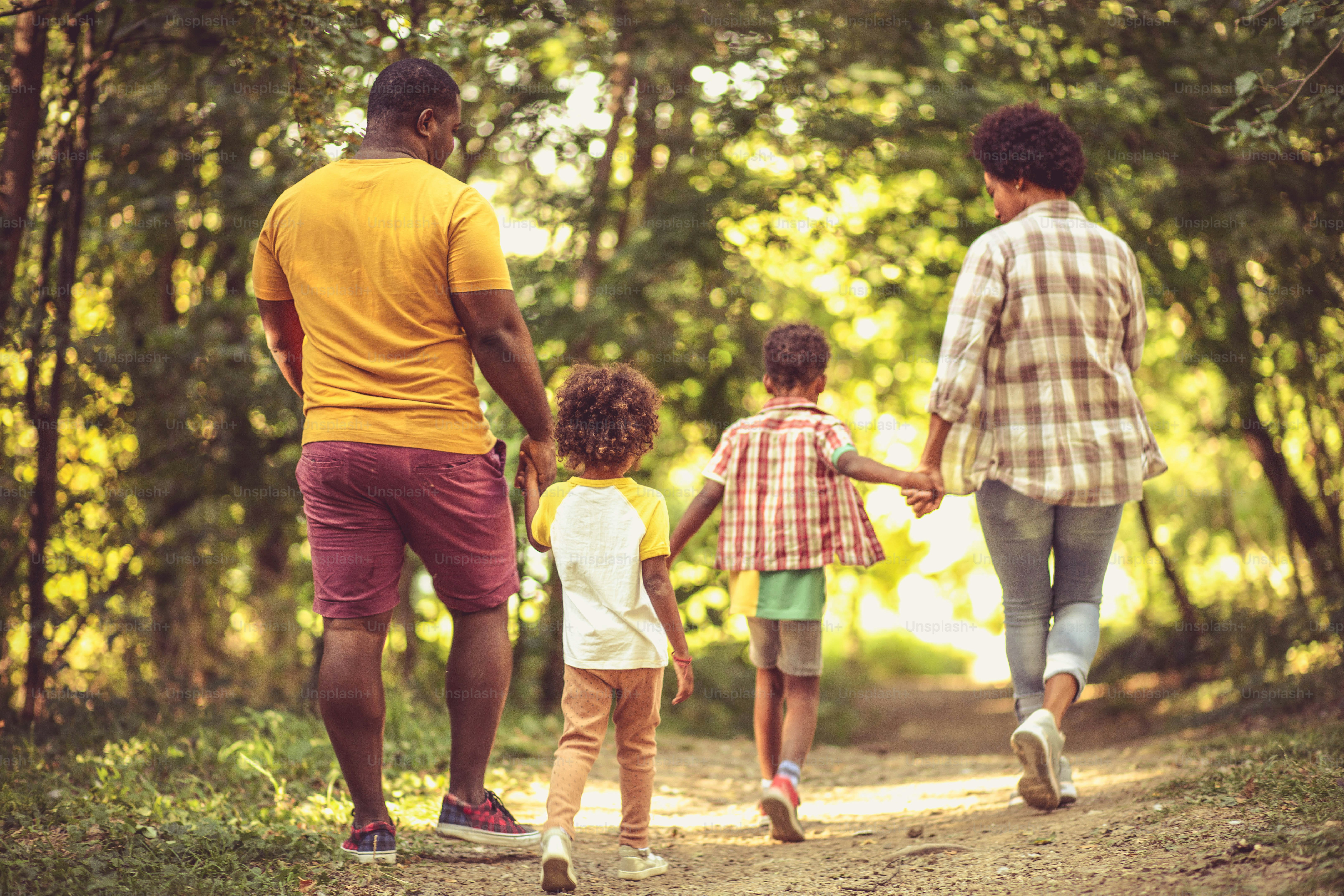 Walk trough park.  African American family having fun outdoors.