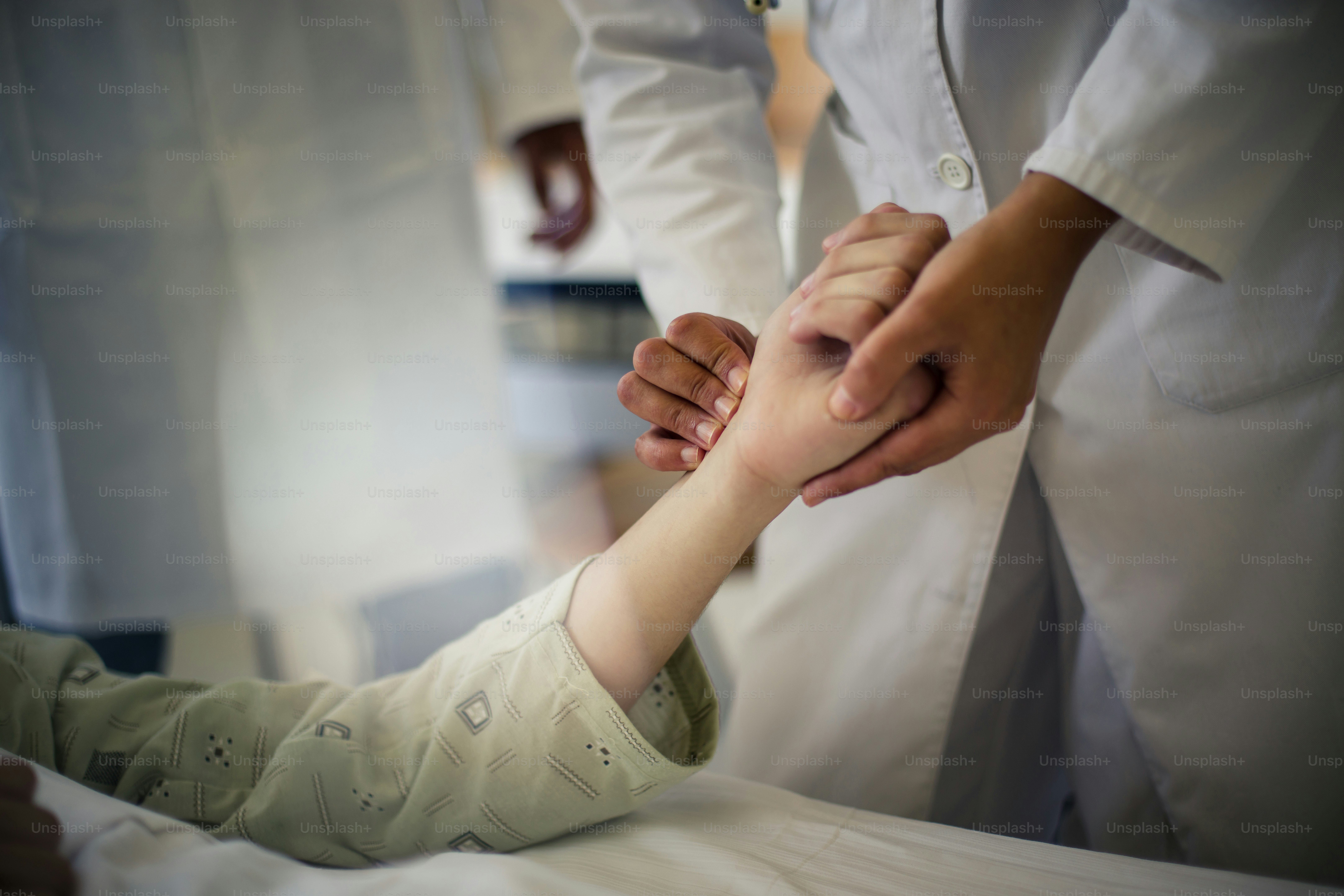Checking blood pressure. Doctor taking man's blood pressure. Focus is on hands.