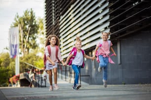 Three school girls outside.