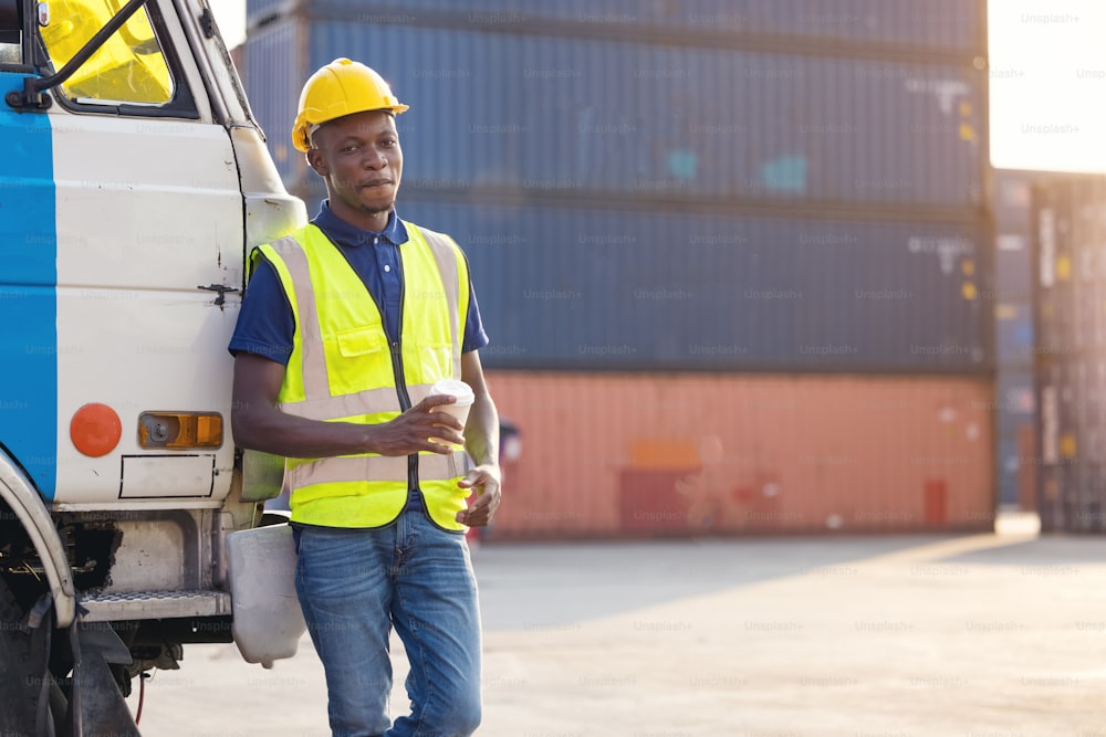 African American businessman drinking coffee, black man have coffee break at worksite outdoors container background