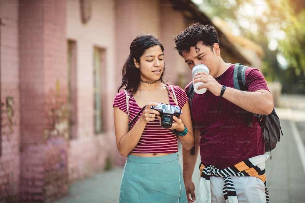 Young couple standing on street.