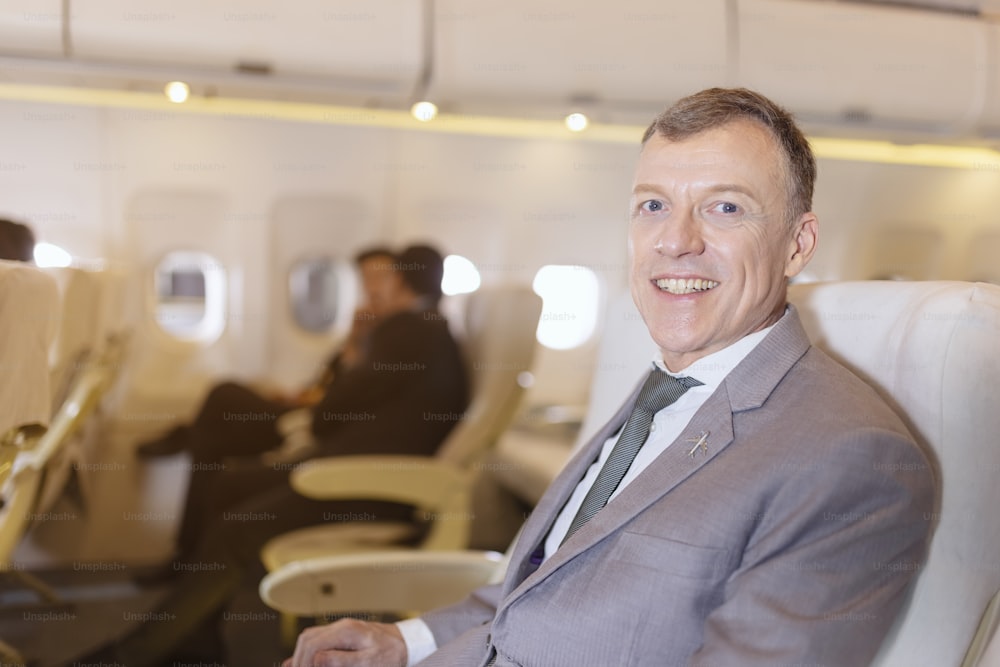 Portrait of businessman on an airplane, Passenger Relaxing