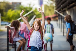 Group of elementary age schoolchildren outside. Focus is on foreground.