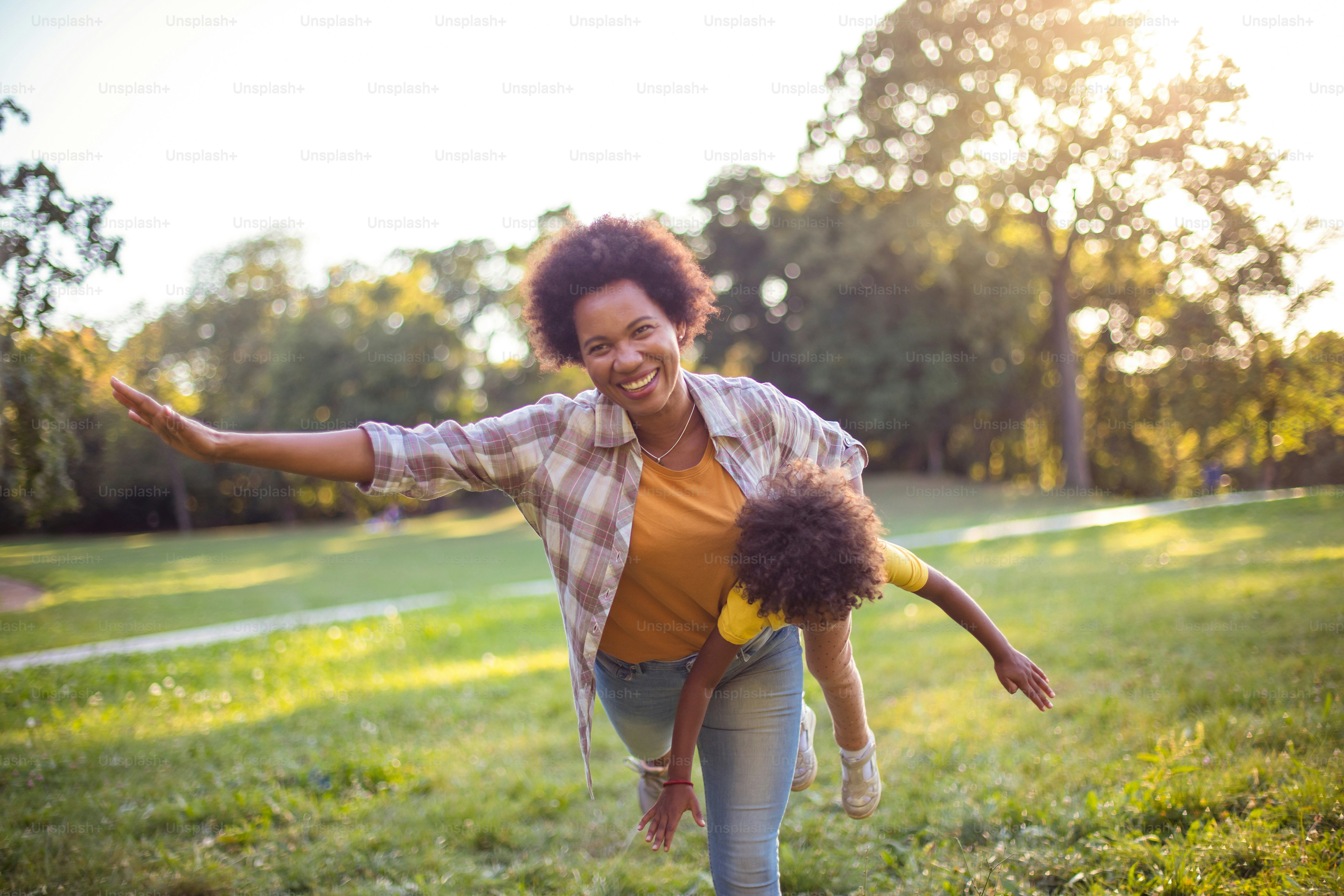 African American mother and daughter playing in the park.