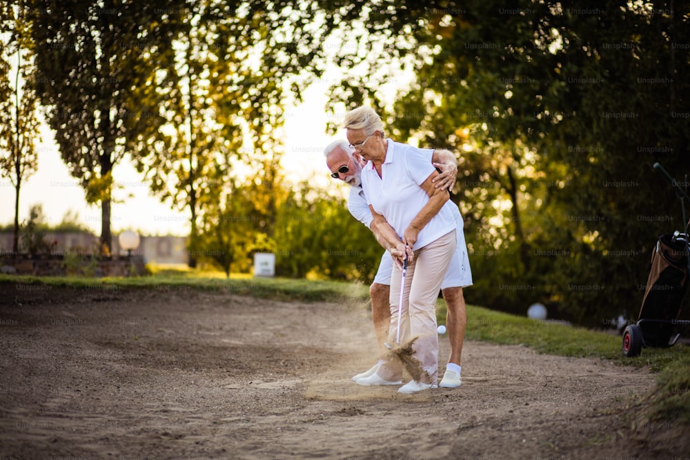 Senior couple playing golf together.