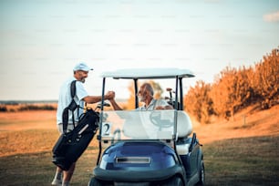 Two senior men golfers on court.