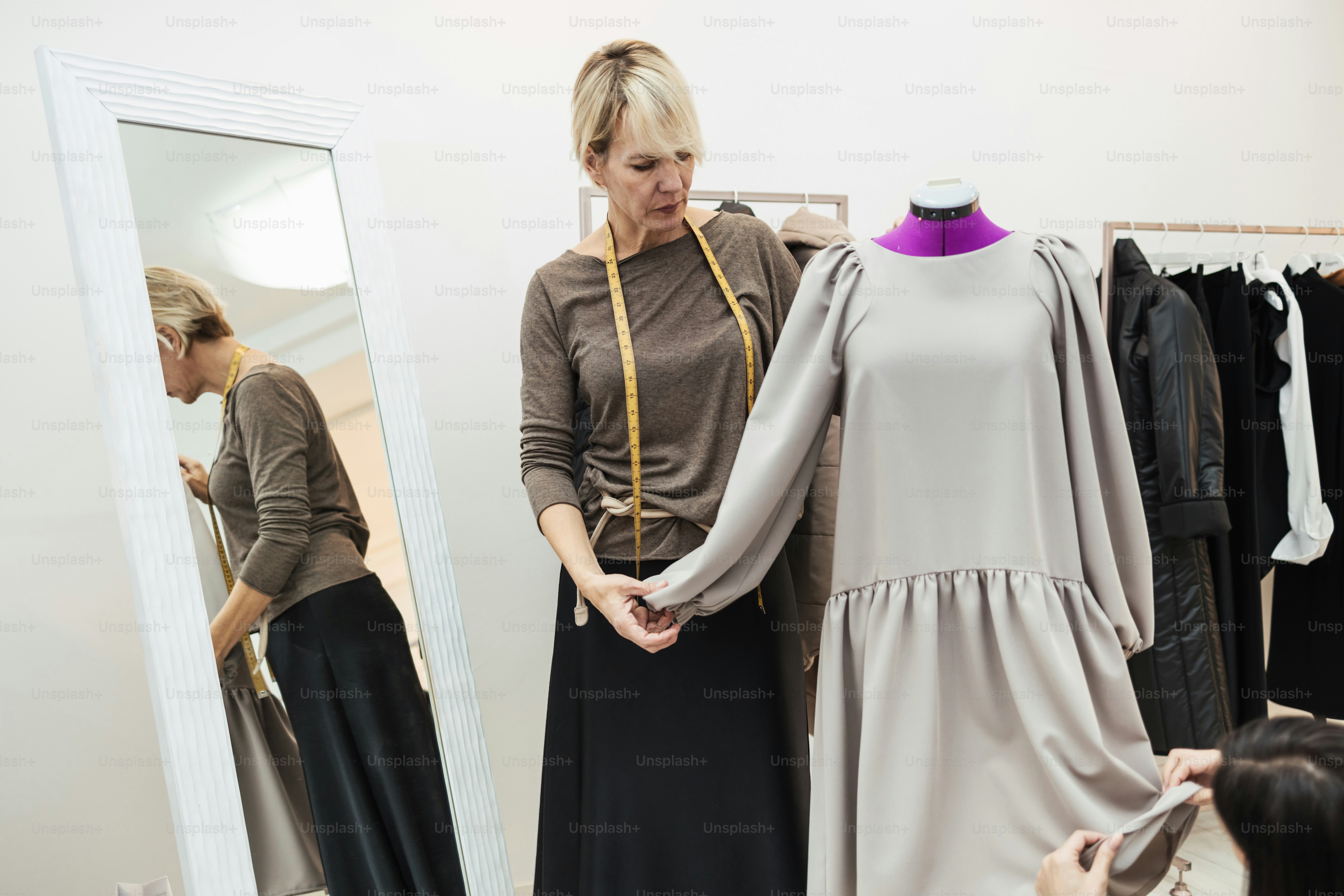 Two professional designers working in fashion studio. Creative people concept.