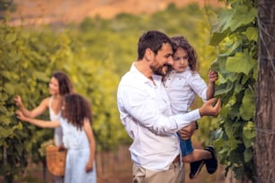 Family in the vineyard. Focus is on foreground.