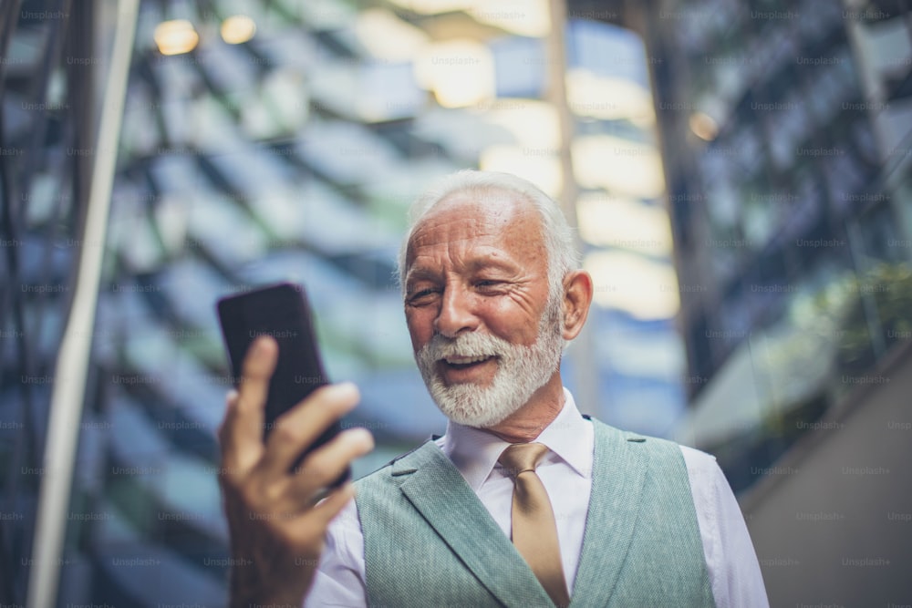 Senior business man using smart phone.