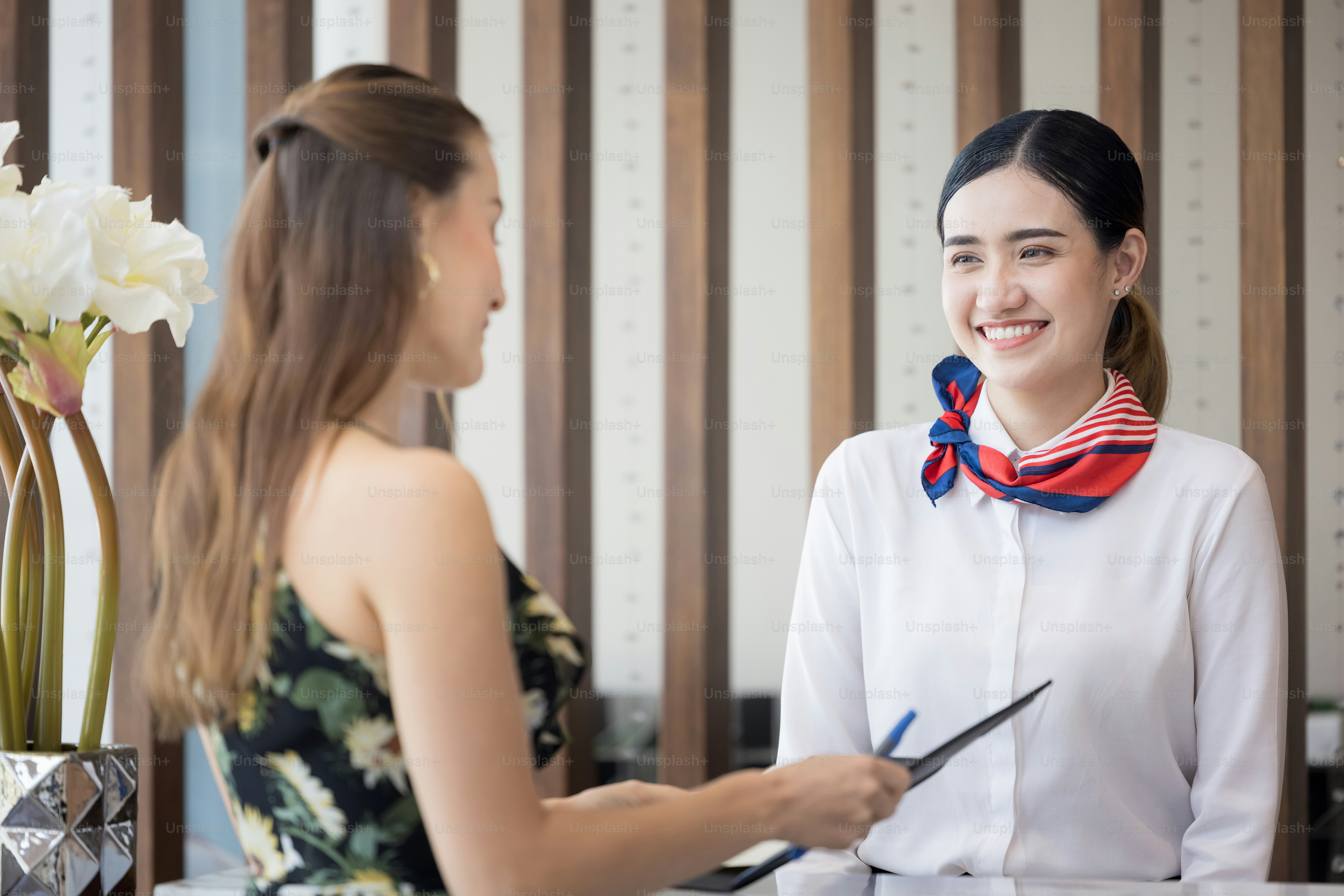 tourist woman going to fill and sign hotel check in registration form at reception counter, kunden service when arrival destination for summer vacation
