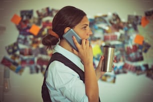 FBI woman in office talking on phone.