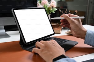 Close up view hand of businessman holding stylus pen pointing on screen of computer tablet.