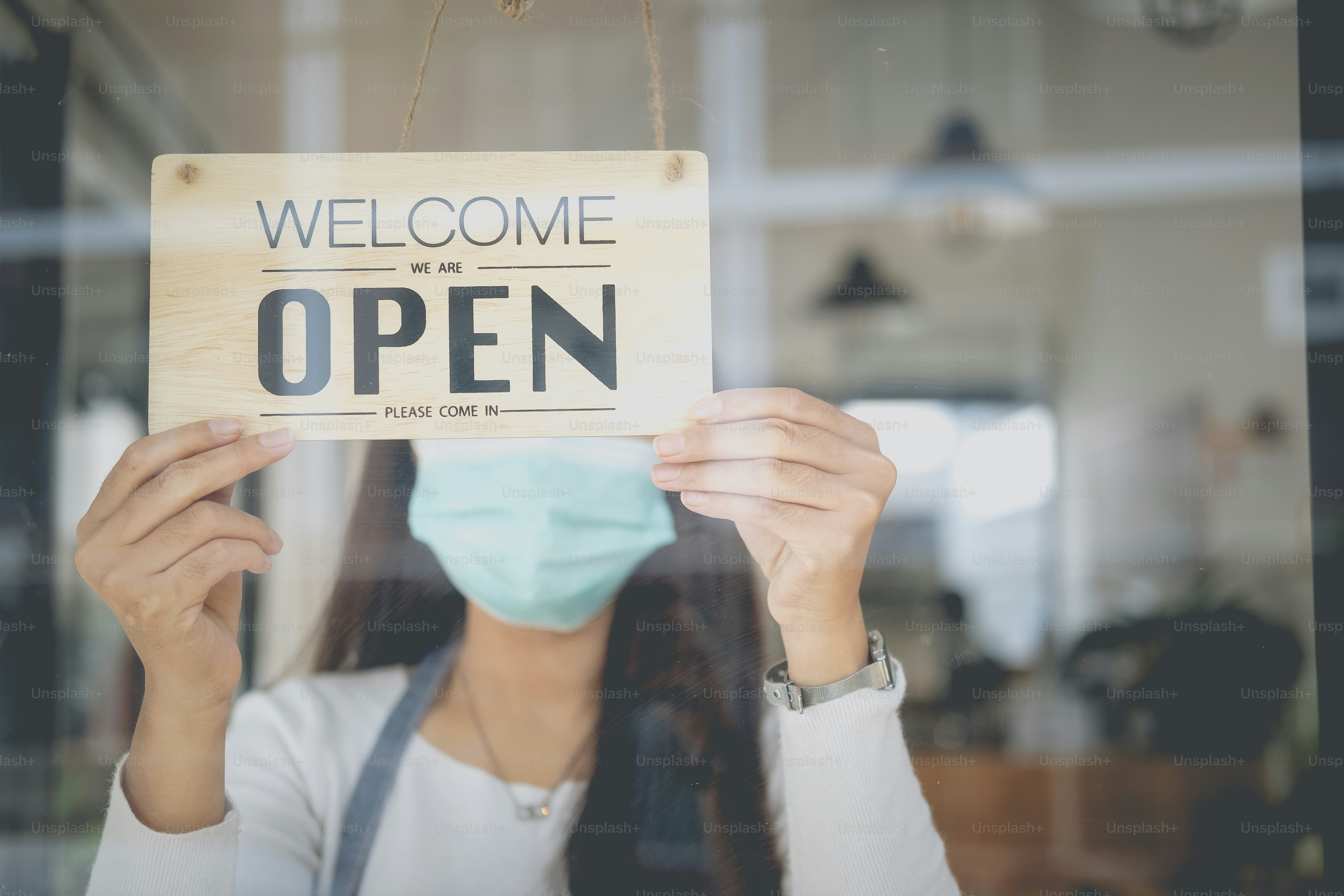 Reopen, Young Asia girl wear face mask turning a sign from closed to ...