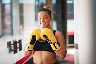 Boxer woman in gym with boxers gloves..