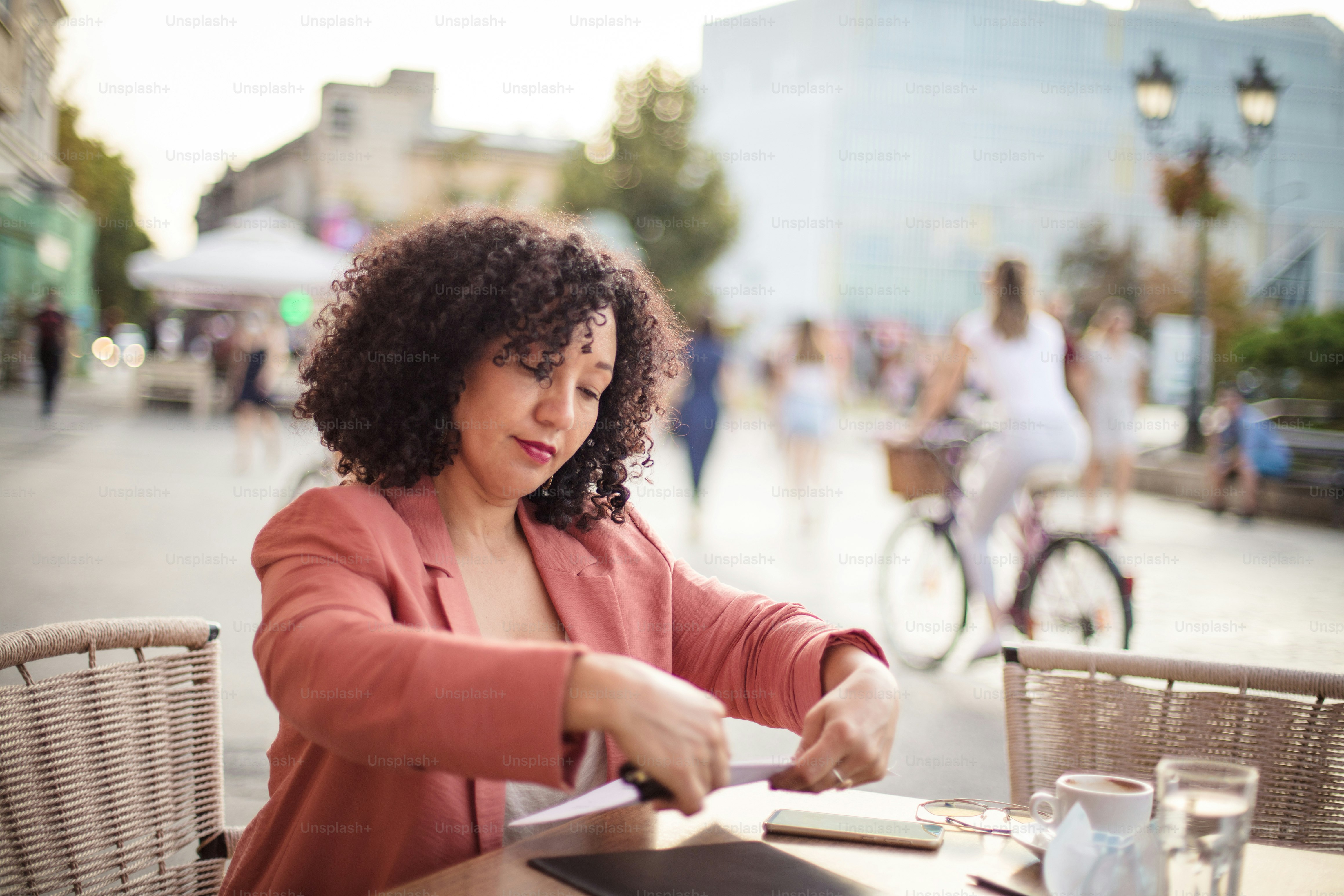 Business woman working on document in café.