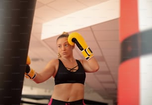 One fit woman training with a punching bag.
