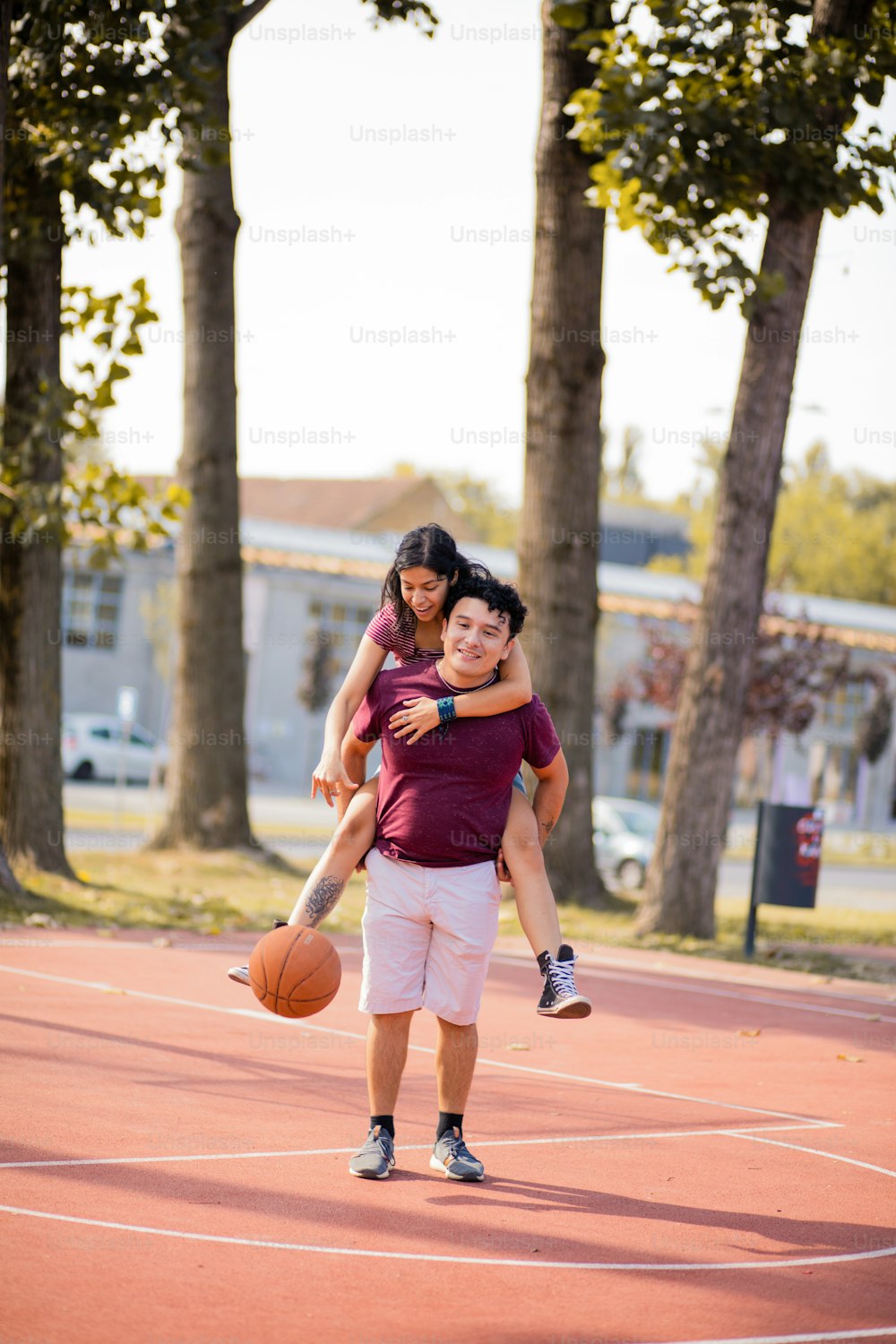 Jovem casal jogando basquete.