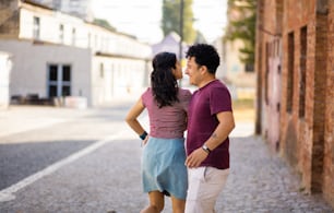 Young couple dancing on street.