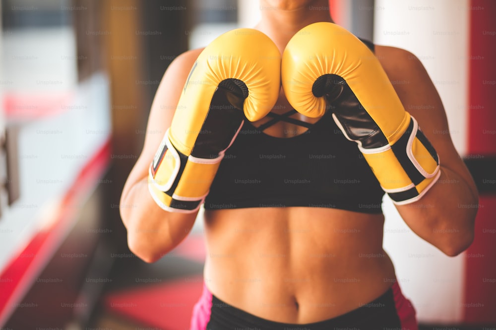 ボクシンググローブをはめた女性。焦点は手袋にあります。