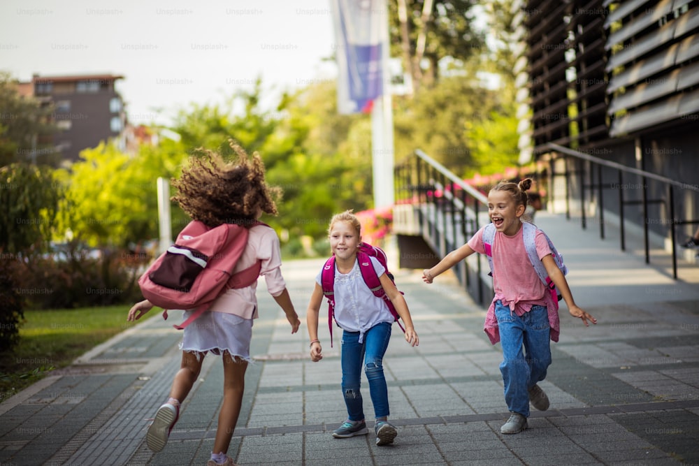 Three school girls outside. Focus is on background.