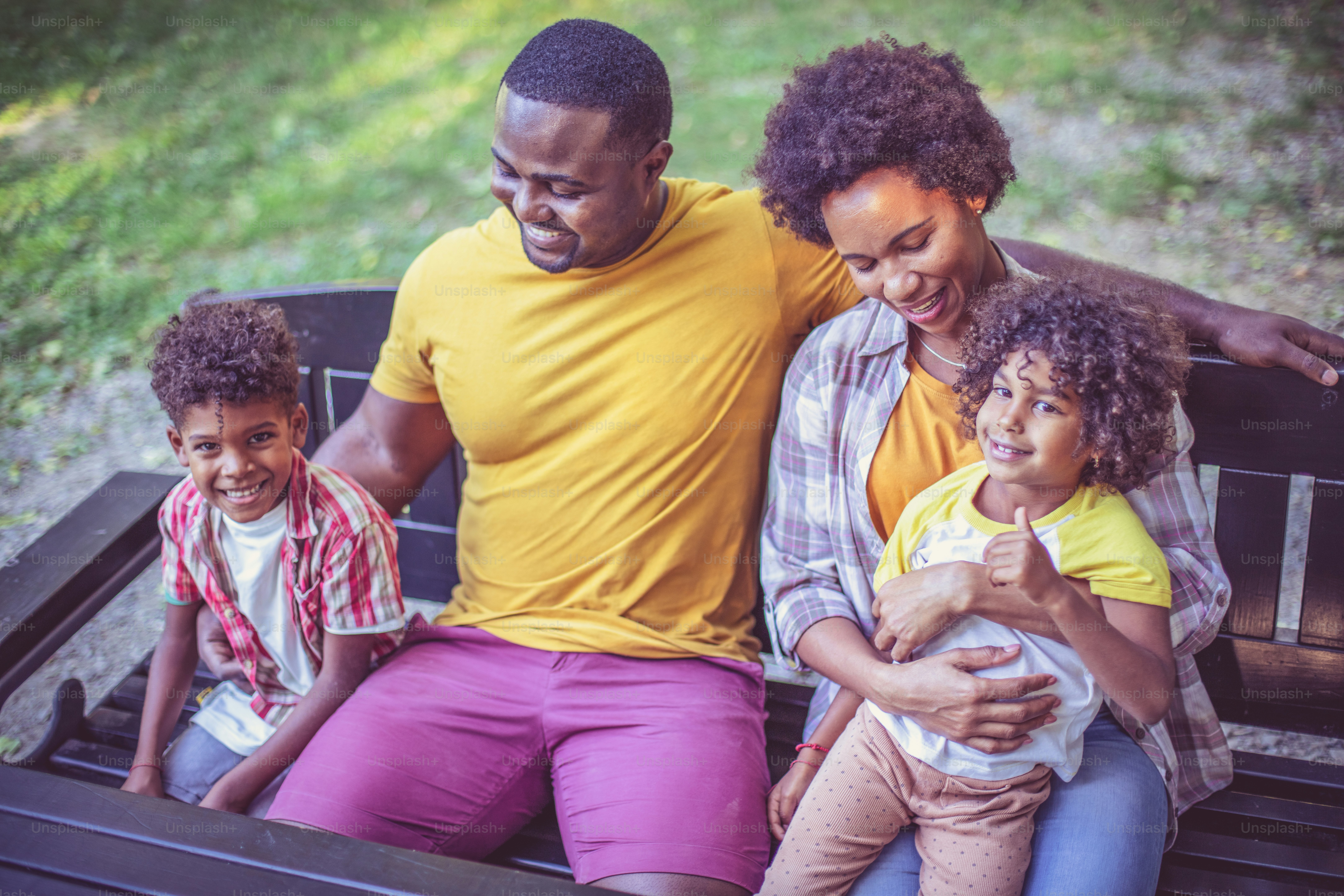 Portrait of happy African American family outdoors.