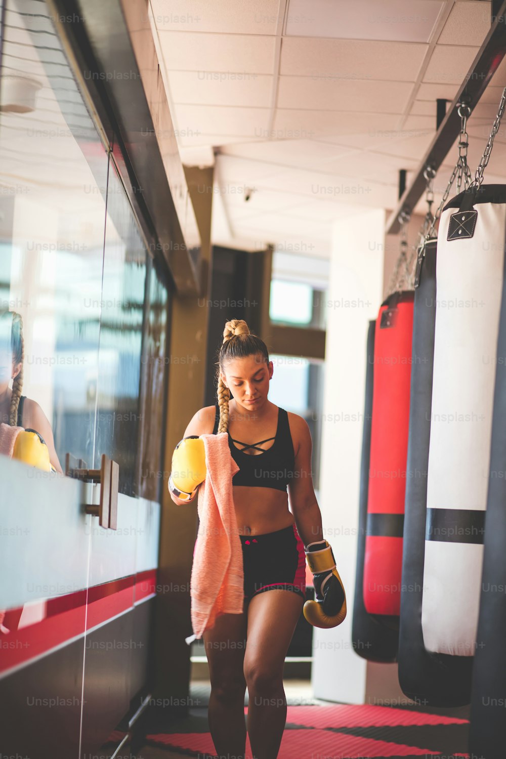 Boxer woman walking in gym.