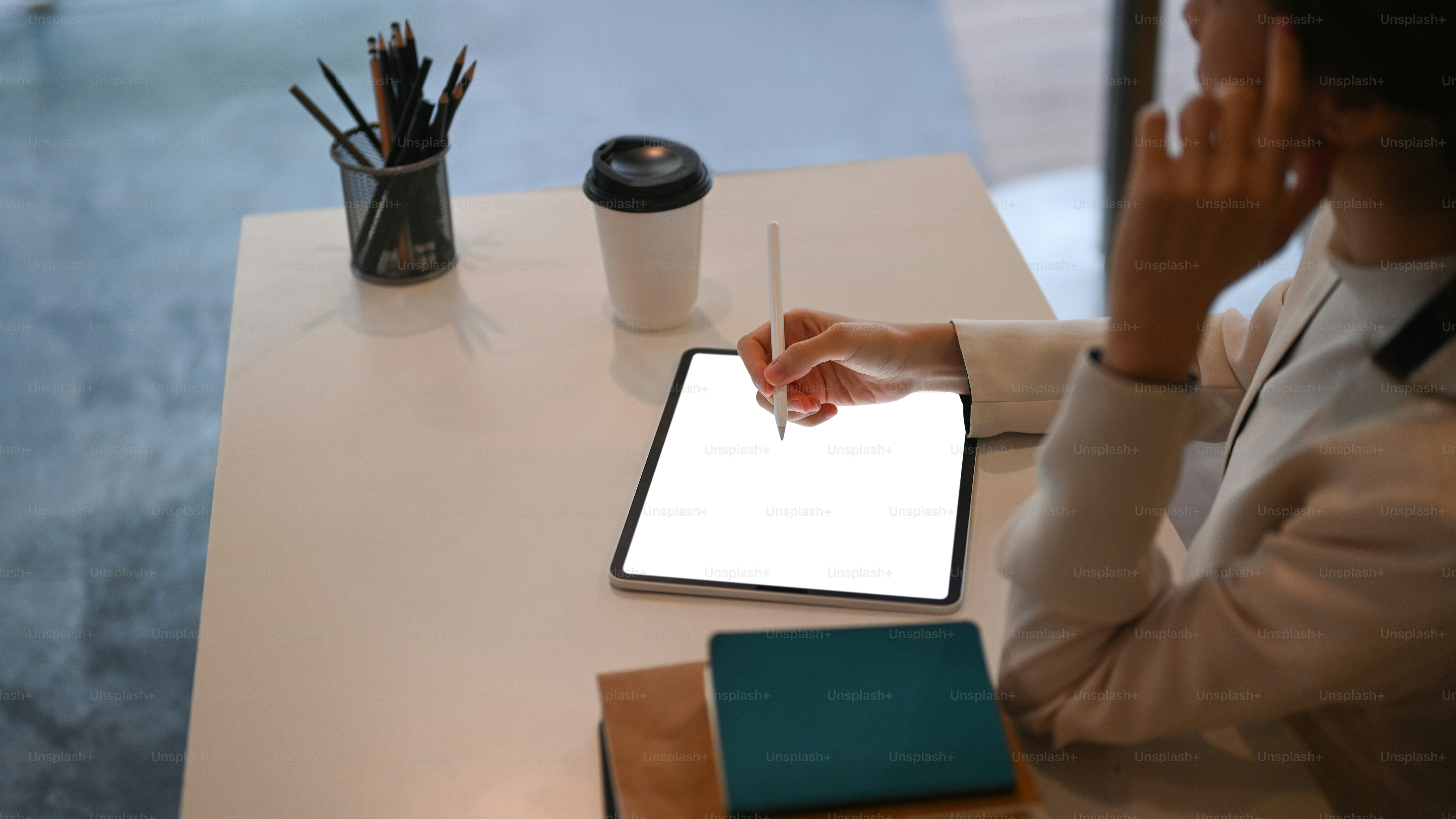 Cropped shot of executives businesswoman working on digital tablet in modern office.