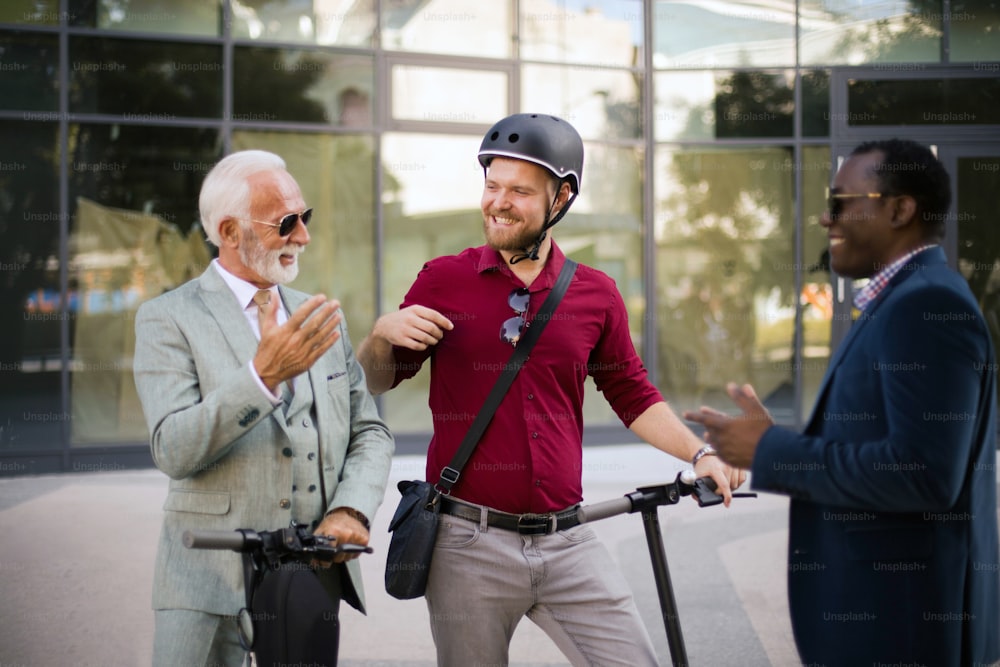 Three business colleagues standing outdoors and discussing.