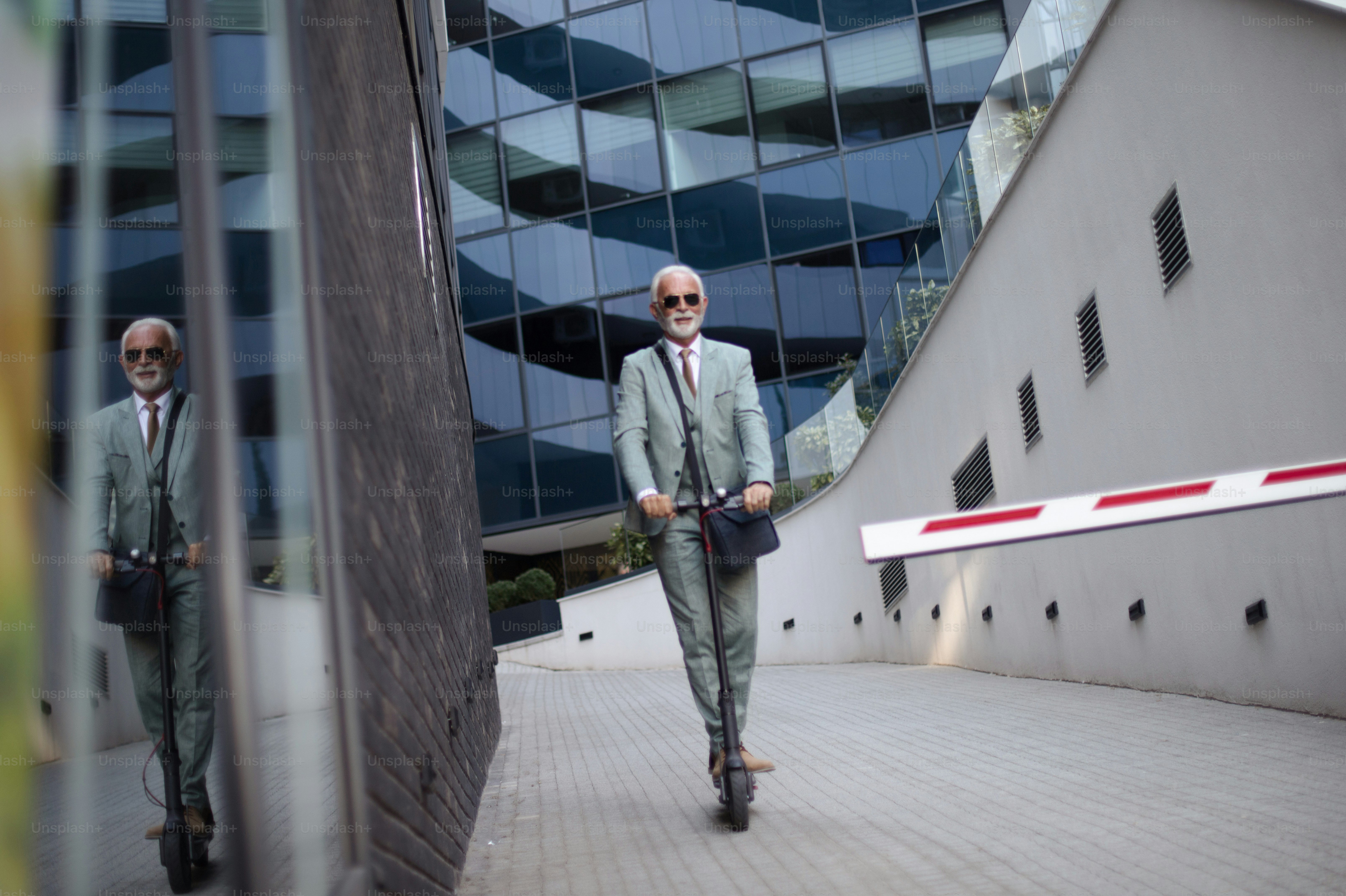 Business man riding electric scooter in the city.