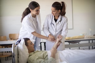 Doctor checking patients blood pressure arm.  Doctor teaches the student how to measure pressure.