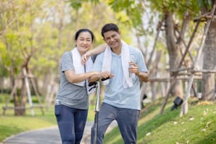 Couple workout and exercise with scooter together outdoor in park