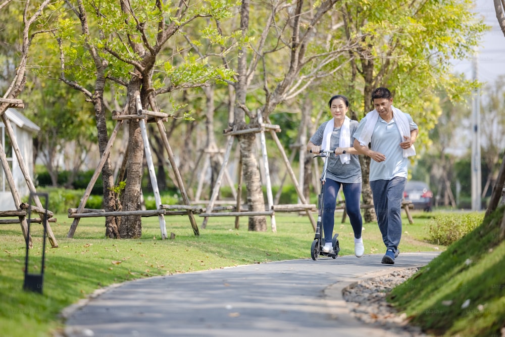Couple workout and exercise with scooter together outdoor in park