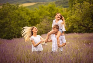 The family stands in a lavender field.