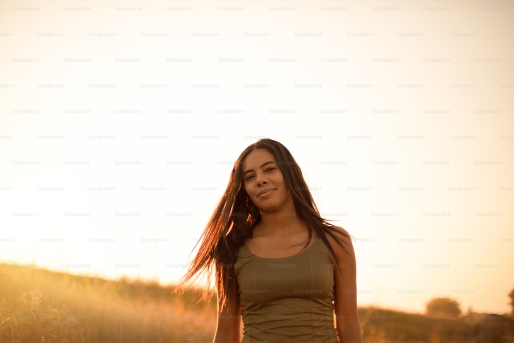 Young woman standing outside on a sunny day.