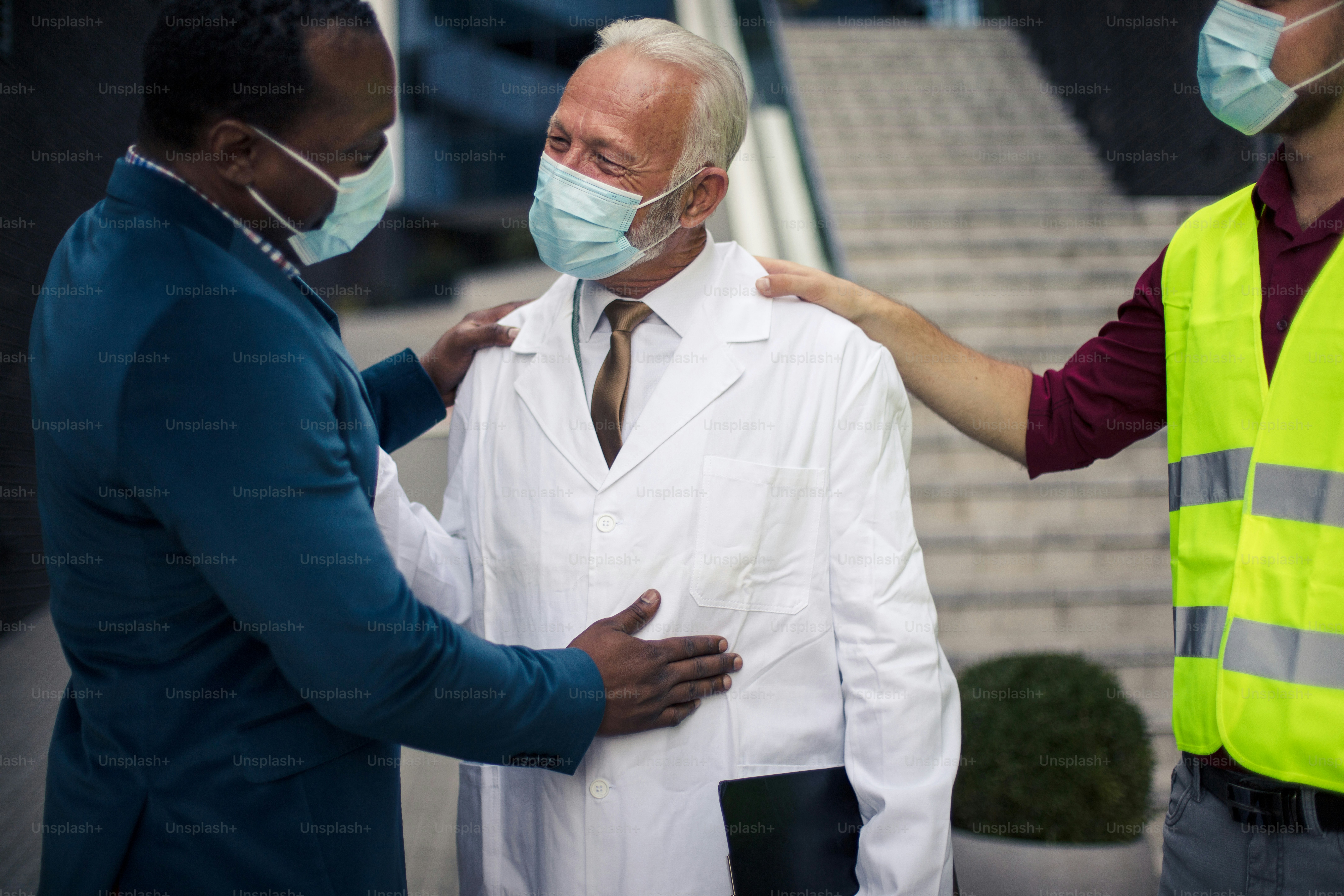 Business man, doctor and engineer talking on street.