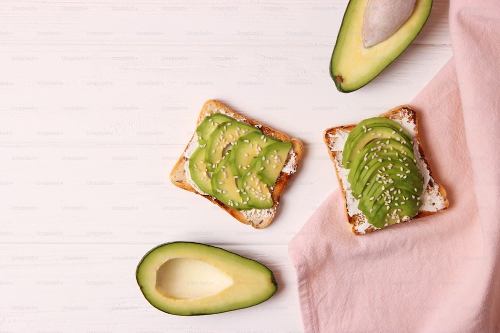 Toasted toast with avocado on a wooden table. High quality photo