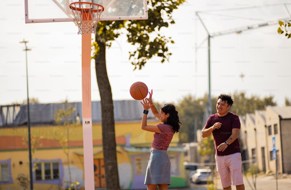 Young couple playing basketball.