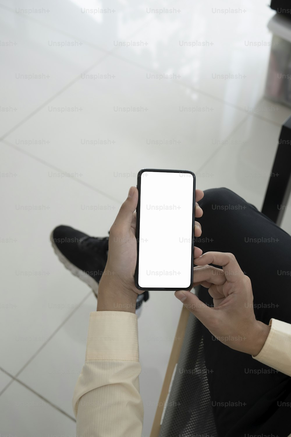 Mock up image of businessman holding smart phone huh white screen.