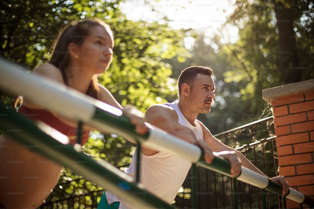 Young sport couple working exercise in the park. Focus is on background.