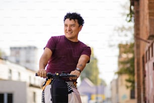 Man riding scooter on the street.